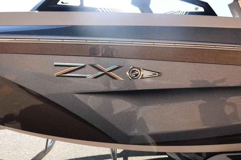 Slide: The Image of 2021 Tigé 21ZX boat side view with sleek design and ZX emblem. - 5