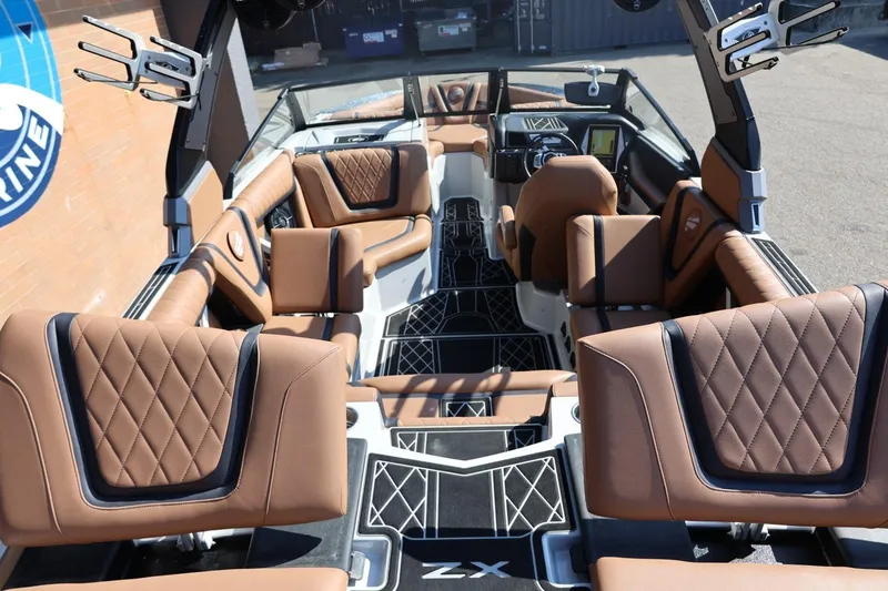 Slide: The Image of 2021 Tigé 21ZX boat interior with luxurious brown leather seating and modern dashboard. - 51