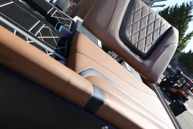 Slide: The Image of 2021 Tigé 21ZX boat interior with tan and black seating, diamond stitching detail. - 52