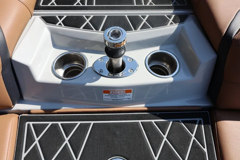 Slide: The Image of 2021 Tigé 21ZX boat interior with cup holders and control knob. - 54