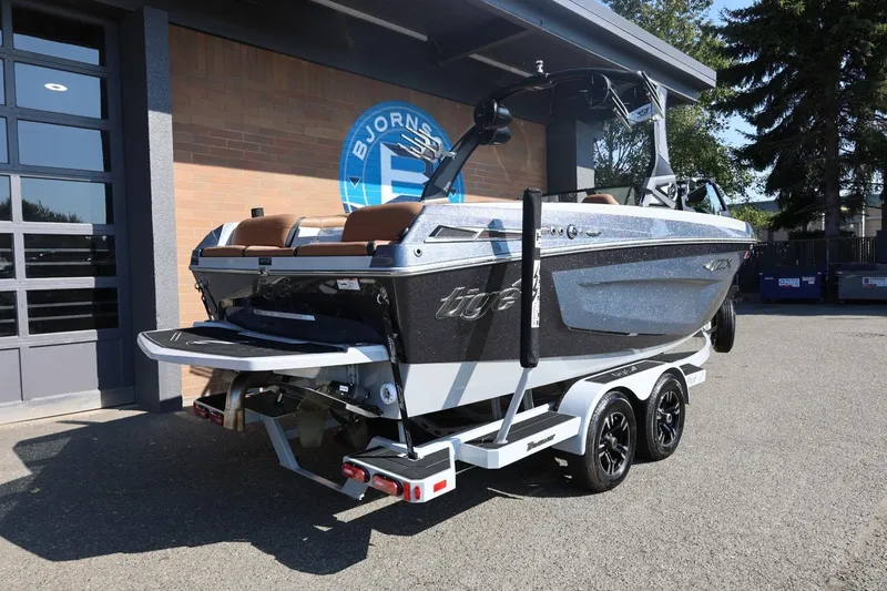 Slide: The Image of 2021 Tigé 21ZX boat on trailer outside a building, showcasing sleek design. - 7