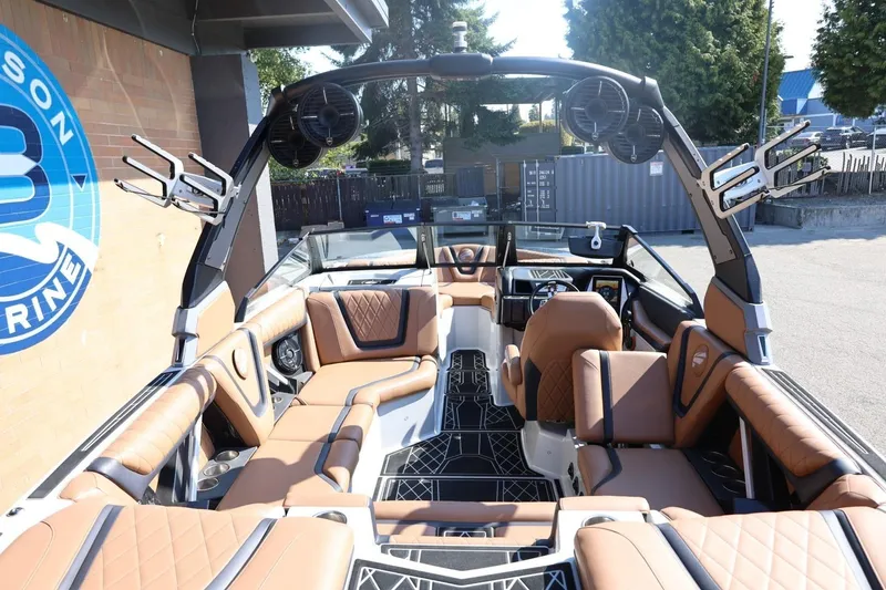Slide: The Image of 2021 Tigé 21ZX boat interior with brown leather seats and modern dashboard. - 9