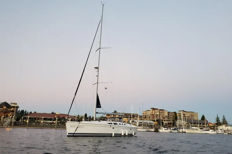 Slide: The Image of Sailboat Hunter 49 (2008) docked at marina during sunset, with buildings in the background. - 11