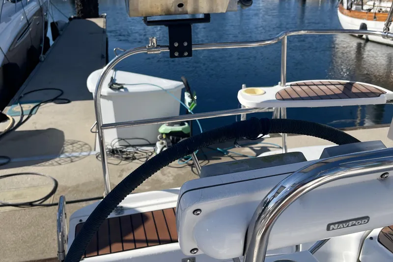 Slide: The Image of Steering wheel and deck of a 2008 Hunter 49 sailboat at a marina. - 17