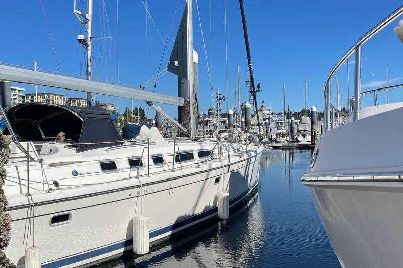Slide: The Image of 2008 Hunter 49 sailboat docked in a marina under clear blue skies. - 18