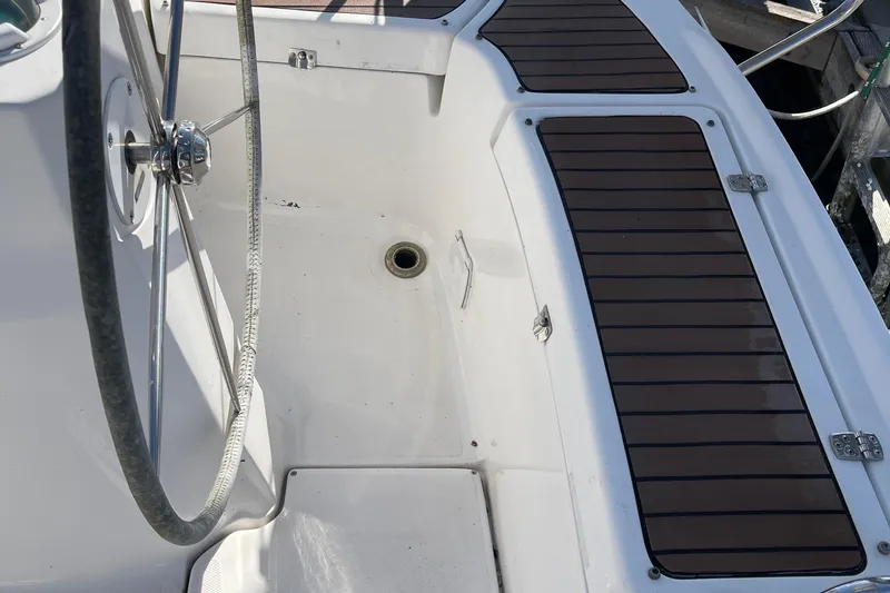 Slide: The Image of Cockpit of 2008 Hunter 49 sailboat with steering wheel and wooden deck panels. - 19