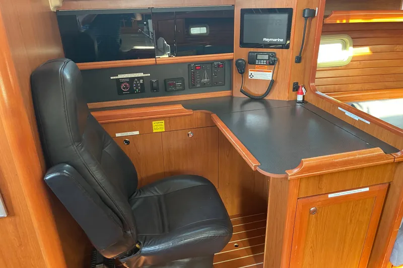 Slide: The Image of Navigation station in 2008 Hunter 49 yacht with control panel and leather chair. - 2