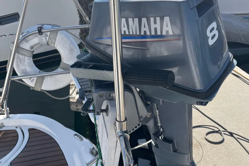 Slide: The Image of Yamaha 8 outboard motor on a 2008 Hunter 49 sailboat, docked with a lifebuoy nearby. - 20