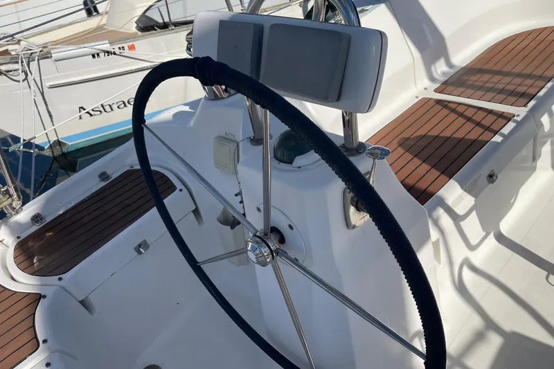 Slide: The Image of Steering wheel of a 2008 Hunter 49 sailboat with wooden deck details. - 22