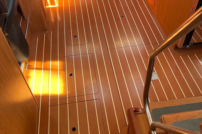 Slide: The Image of Teak interior flooring of 2008 Hunter 49 yacht, featuring sleek design and warm lighting. - 33