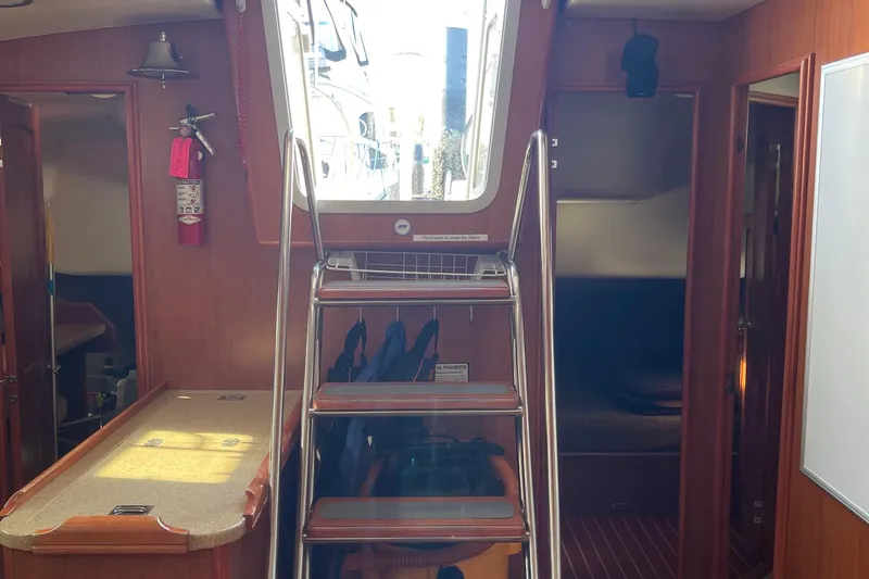 Slide: The Image of Interior of a 2008 Hunter 49 sailboat with stairs and wooden cabinetry. - 35