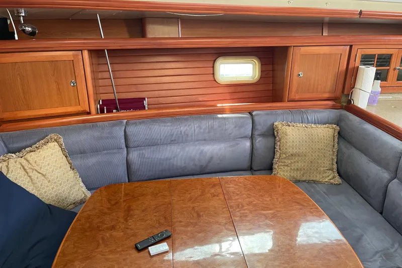 Slide: The Image of Luxurious interior of 2008 Hunter 49 yacht with plush seating and wooden accents. - 38