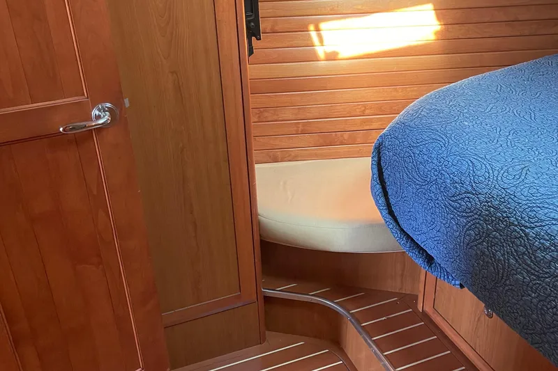 Slide: The Image of Interior of 2008 Hunter 49 yacht with wooden paneling and blue quilted bedding. - 39
