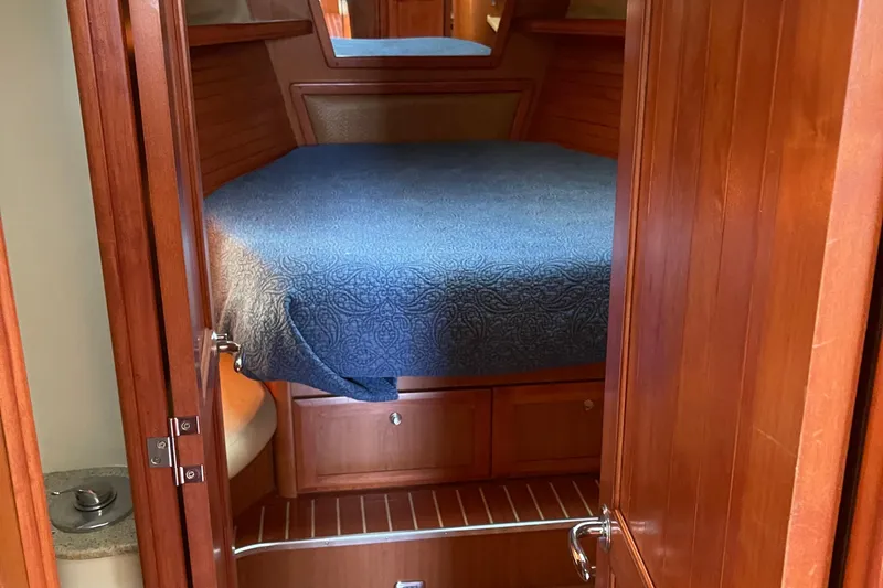 Slide: The Image of Cozy cabin interior of 2008 Hunter 49 yacht with wooden finish and blue bedding. - 40
