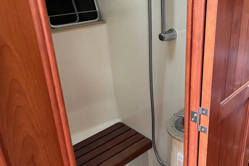 Slide: The Image of Shower area in 2008 Hunter 49 yacht with wooden bench and stainless fixtures. - 43