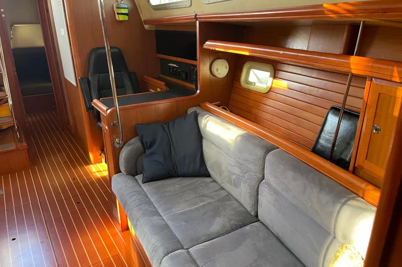 Slide: The Image of Interior of 2008 Hunter 49 yacht with wooden paneling and cozy seating area. - 45