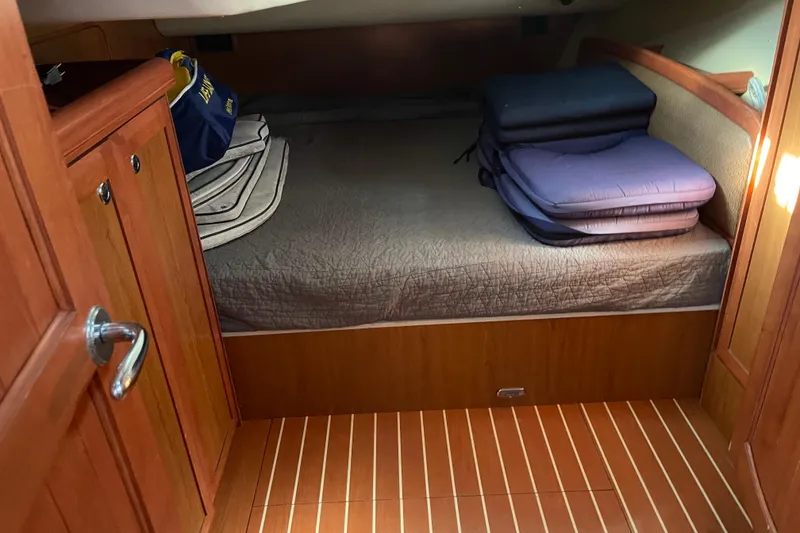 Slide: The Image of Cozy cabin interior of 2008 Hunter 49 sailboat with wooden finish and bedding. - 47