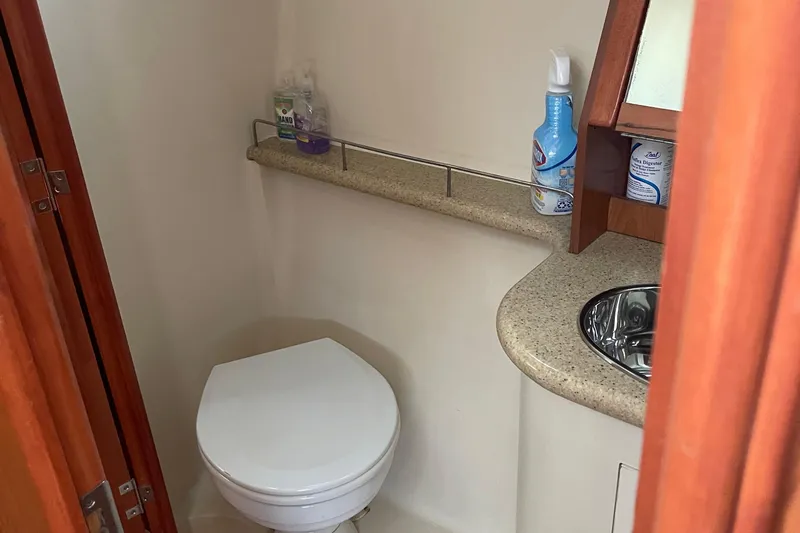 Slide: The Image of Compact bathroom in a 2008 Hunter 49 yacht, featuring a toilet and sink. - 48