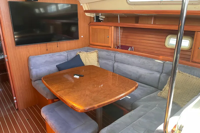Slide: The Image of Interior of 2008 Hunter 49 yacht with cozy seating and wooden table. - 52