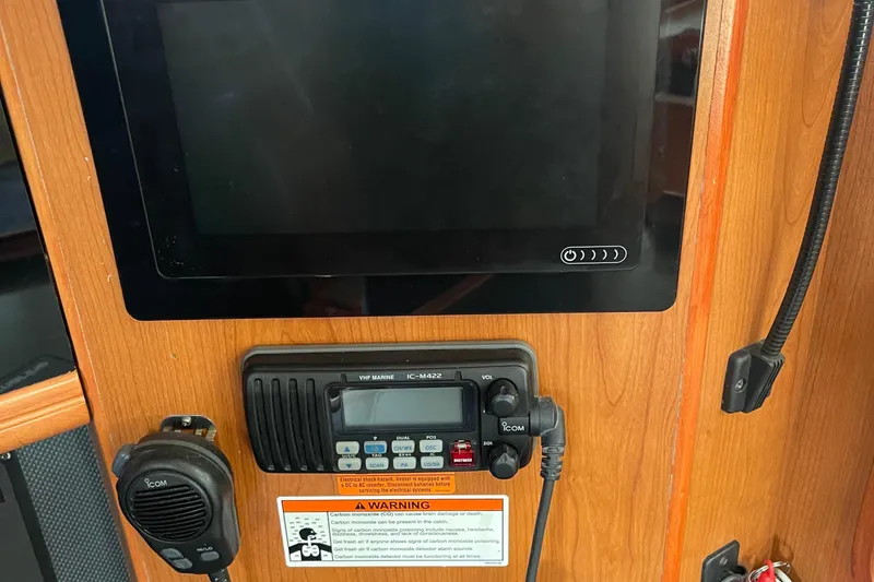 Slide: The Image of Control panel of a 2008 Hunter 49 yacht with VHF marine radio and display screen. - 53