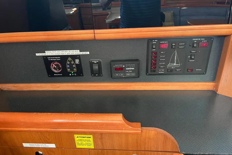 Slide: The Image of Control panel of a 2008 Hunter 49 yacht with various gauges and switches. - 54