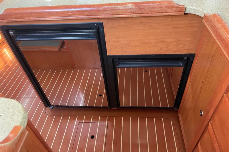 Slide: The Image of Wooden interior of a 2008 Hunter 49 yacht with built-in storage compartments. - 58