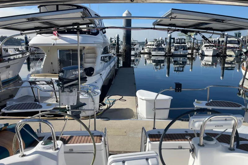 Slide: The Image of Marina view with 2008 Hunter 49 sailboat, surrounded by yachts and calm water reflections. - 73
