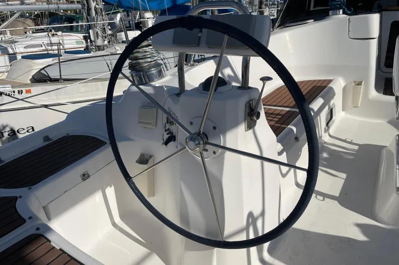 Slide: The Image of Steering wheel of a 2008 Hunter 49 sailboat, docked in a marina. - 74