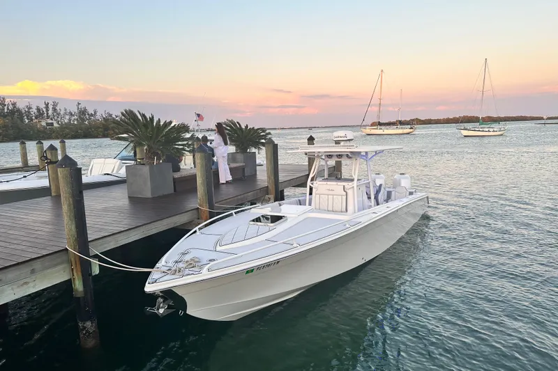 Slide: The Image of 2005 Marlago 35 boat docked at sunset with sailboats in the background. - 20