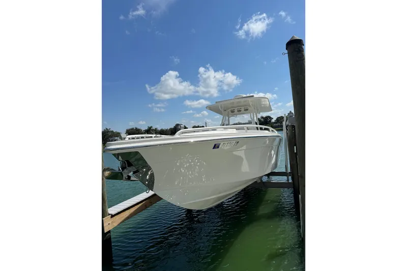 Slide: The Image of 2005 Marlago 35 boat docked on a sunny day with clear blue skies. - 21