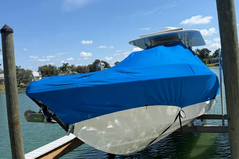 Slide: The Image of Covered 2005 Marlago 35 boat docked on a sunny day. - 25