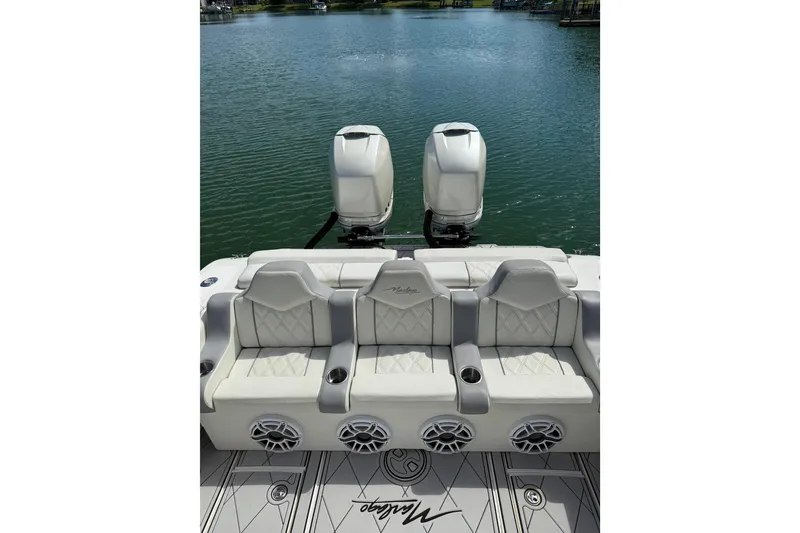 Slide: The Image of 2005 Marlago 35 boat with dual engines and luxurious seating on a calm lake. - 28