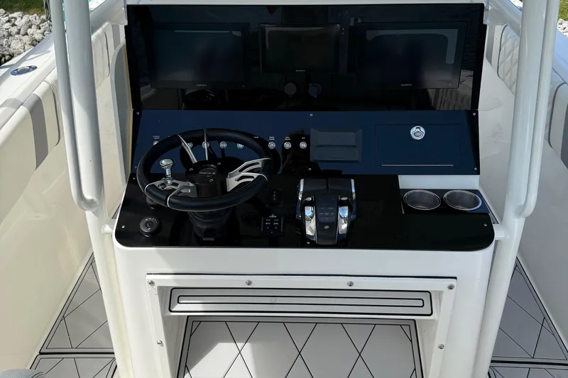 Slide: The Image of Helm of 2005 Marlago 35 boat with steering wheel and control panel. - 34