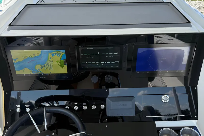 Slide: The Image of Dashboard of a 2005 Marlago 35 boat with Garmin navigation displays. - 35