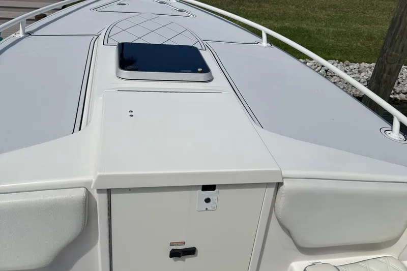 Slide: The Image of 2005 Marlago 35 boat deck with sleek design and storage compartment. - 40