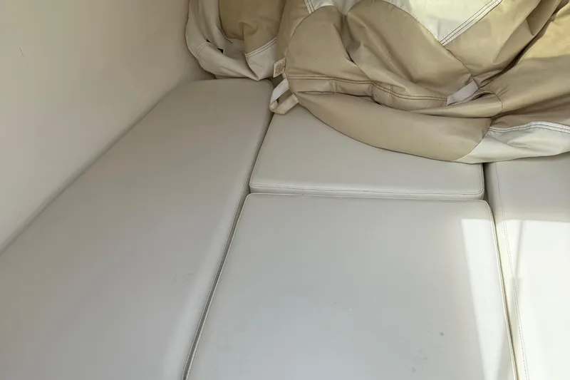 Slide: The Image of Interior seating of a 2005 Marlago 35 boat with beige cushions. - 41