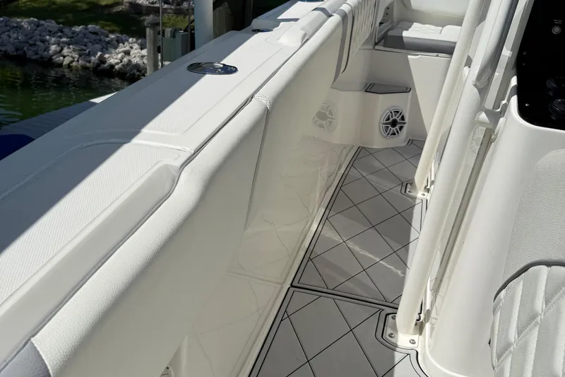 Slide: The Image of Interior view of a 2005 Marlago 35 boat, featuring white seating and sleek flooring. - 45