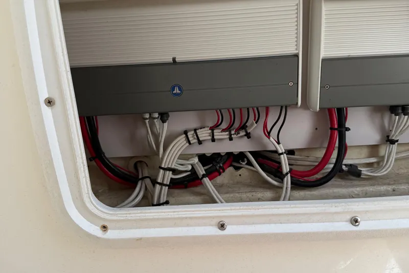 Slide: The Image of Electrical wiring and components inside a 2005 Marlago 35 boat compartment. - 47