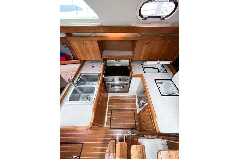 Slide: The Image of Galley view of sinks, stove top, oven, and refrigerator access from top and front - 13