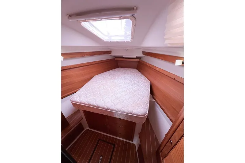 Slide: The Image of Master cabin and berth forward with access from both sides and traditional mattress. - 15