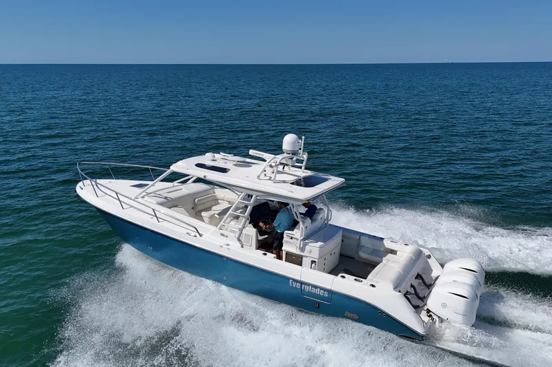 Slide: The Image of 2017 Everglades 360LXC boat cruising on open water, showcasing sleek design and powerful engines. - 0