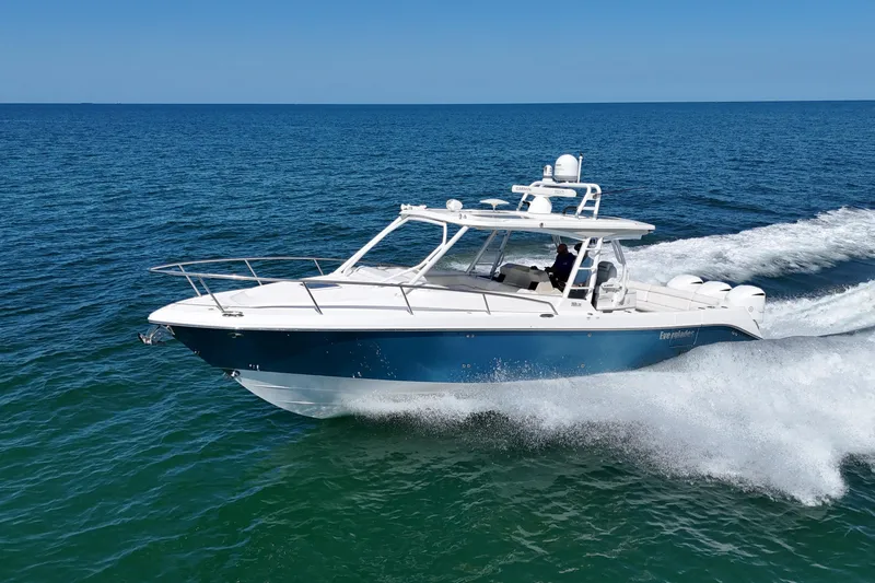 Slide: The Image of 2017 Everglades 360LXC boat cruising on open water, showcasing sleek design and performance. - 1