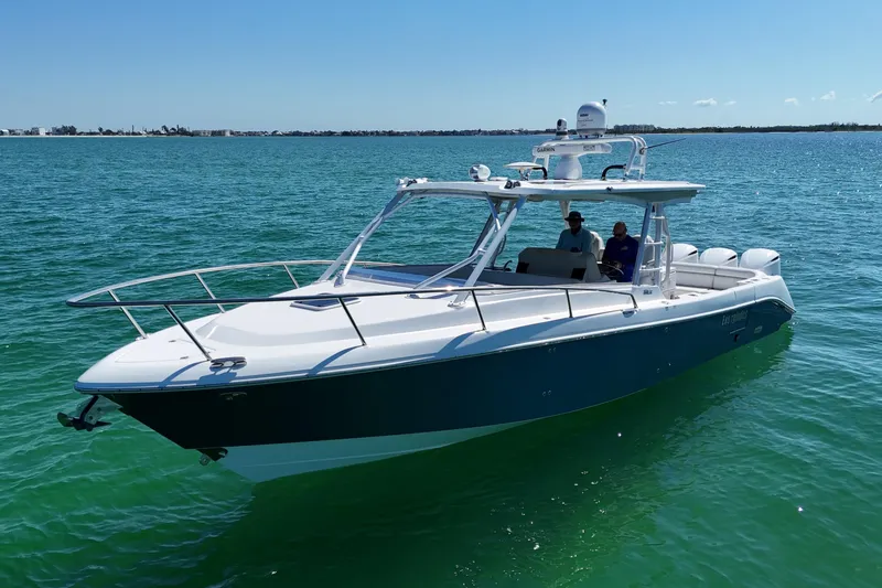 Slide: The Image of 2017 Everglades 360LXC boat cruising on clear blue water under a sunny sky. - 10