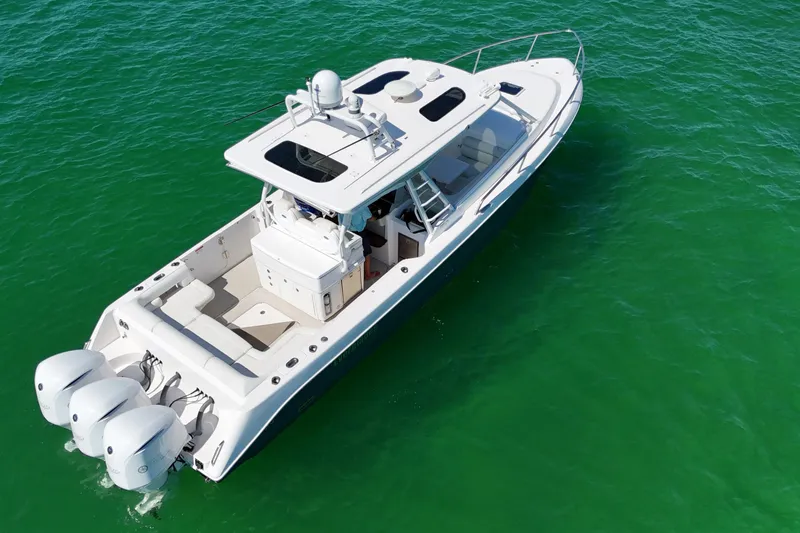 Slide: The Image of 2017 Everglades 360LXC boat with triple engines on clear green water. - 11