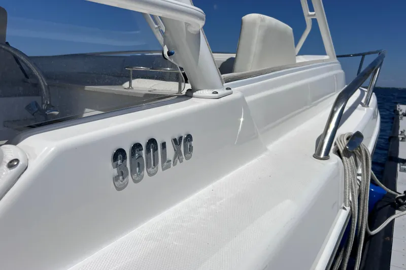 Slide: The Image of 2017 Everglades 360LXC boat side view with railing and ocean backdrop. - 18