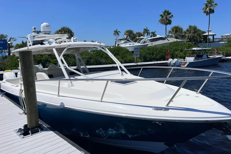 Slide: The Image of 2017 Everglades 360LXC boat docked, featuring sleek design and advanced navigation equipment. - 19