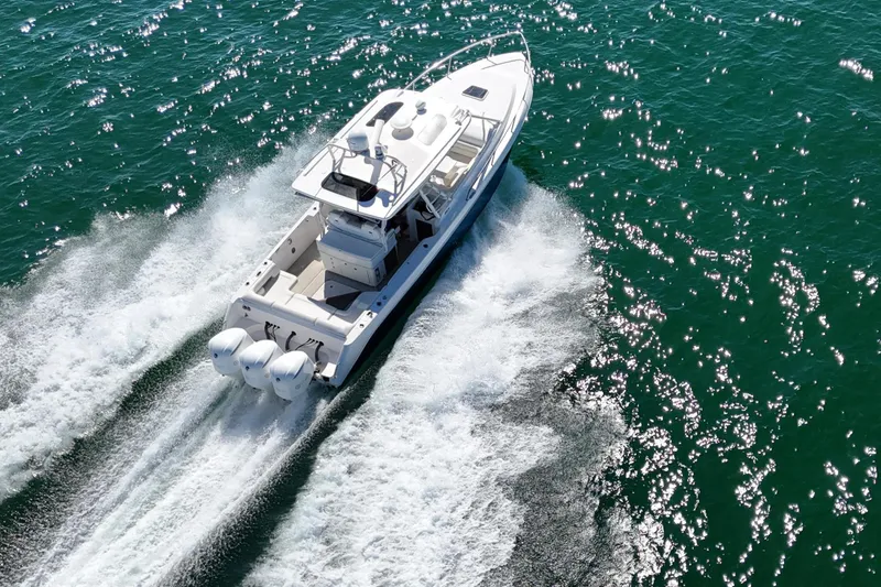 Slide: The Image of 2017 Everglades 360LXC boat cruising on open water, aerial view. - 2