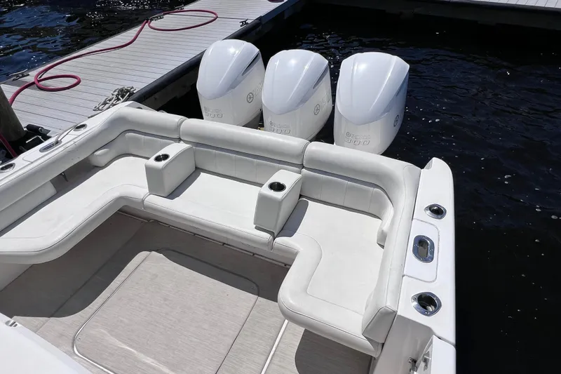 Slide: The Image of 2017 Everglades 360LXC boat with triple Yamaha engines, docked by the water. - 22