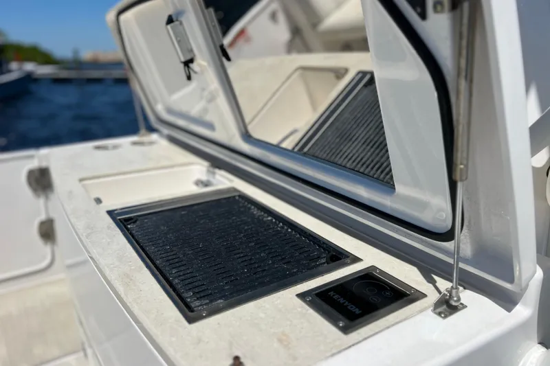 Slide: The Image of 2017 Everglades 360LXC boat grill and storage compartment detail. - 27