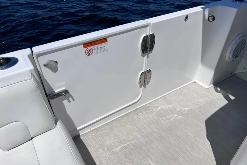 Slide: The Image of 2017 Everglades 360LXC boat interior with white seating and ocean view. - 33